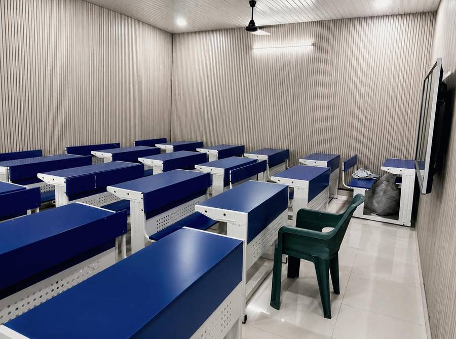 Representative image of a modern classroom interior with rows of desks